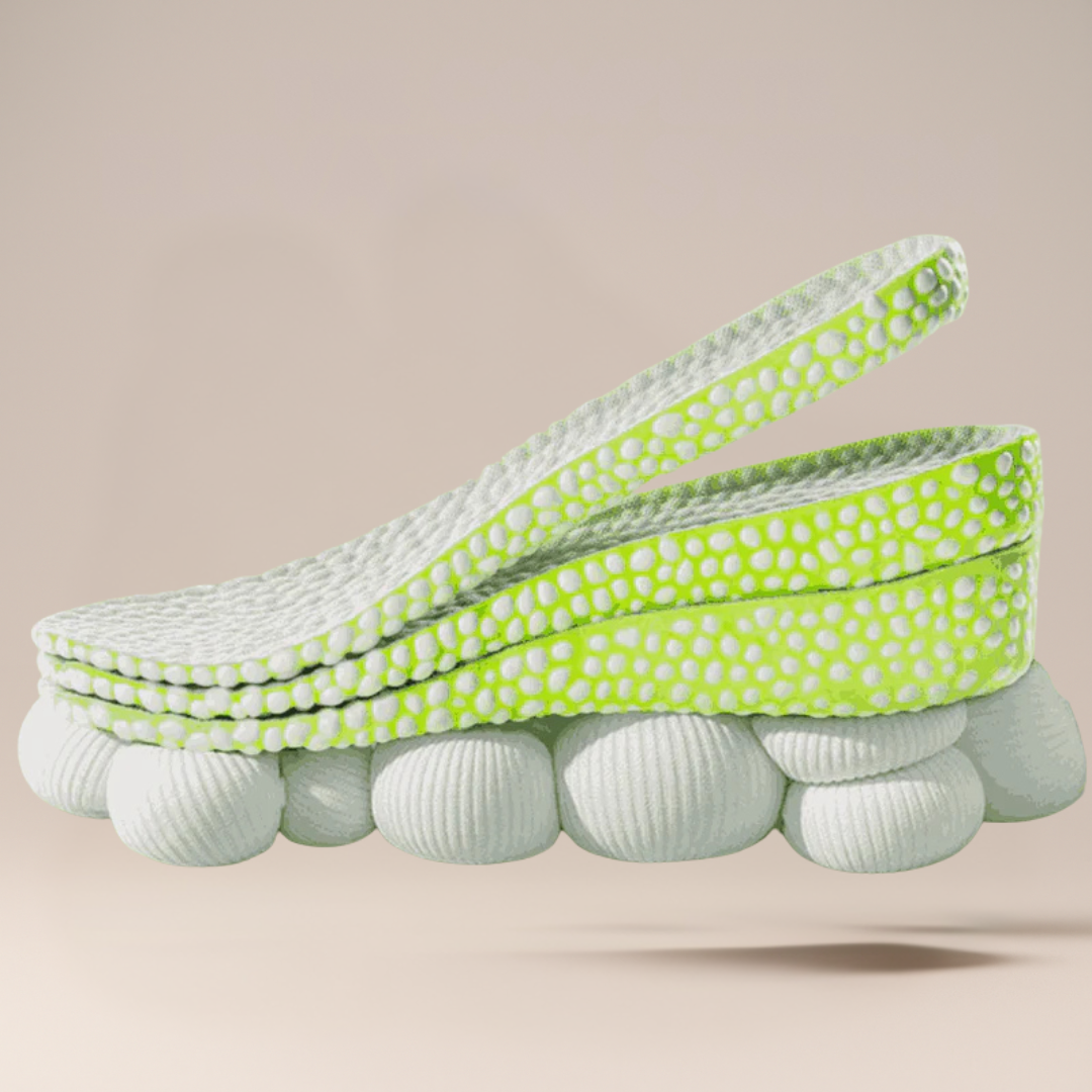 Stack of white and green polka dot shoes on a beige background