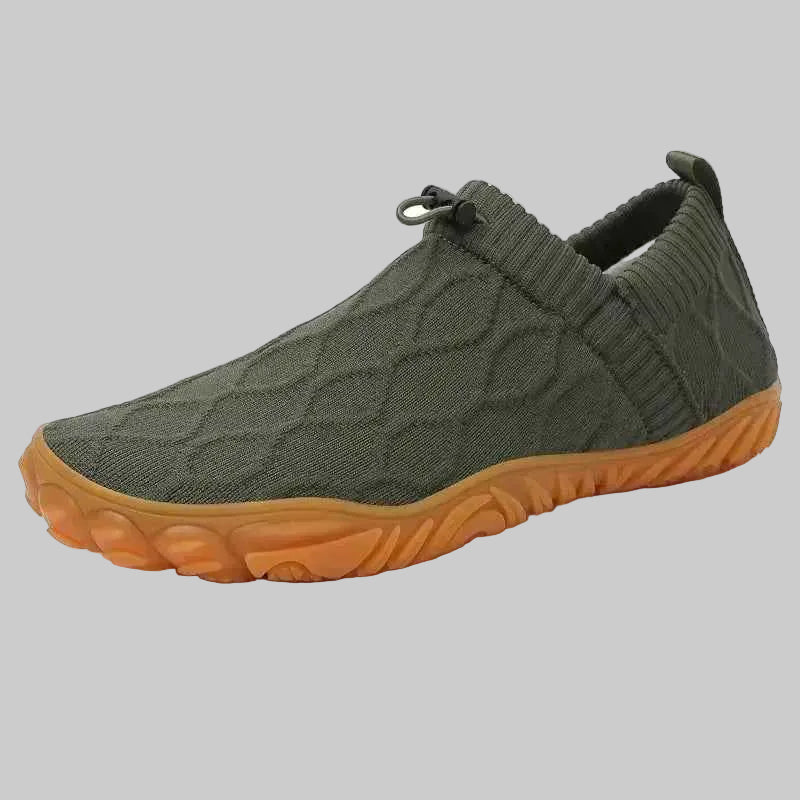 Green slip-on shoe with orange sole on a white background