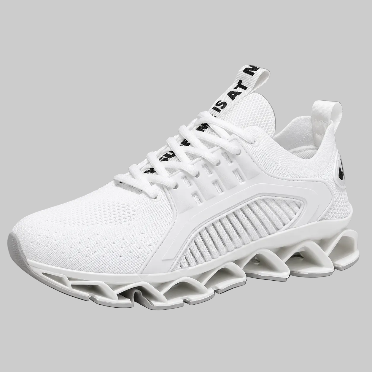 A white athletic sneaker with a chunky, sculpted wavy sole, white mesh upper, and black text accents on the tongue pull tab and laces, set against a solid gray background.
