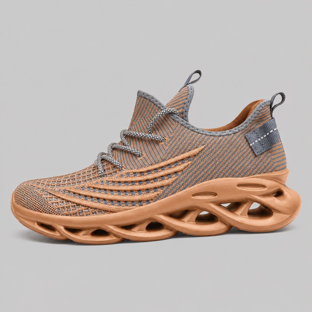 A single low-top sneaker shown in profile against a solid gray background. The shoe features a textured knit upper in a mix of brown and gray, gray laces, and a thick, sculptural, hollow-out sole in a warm tan/caramel color.