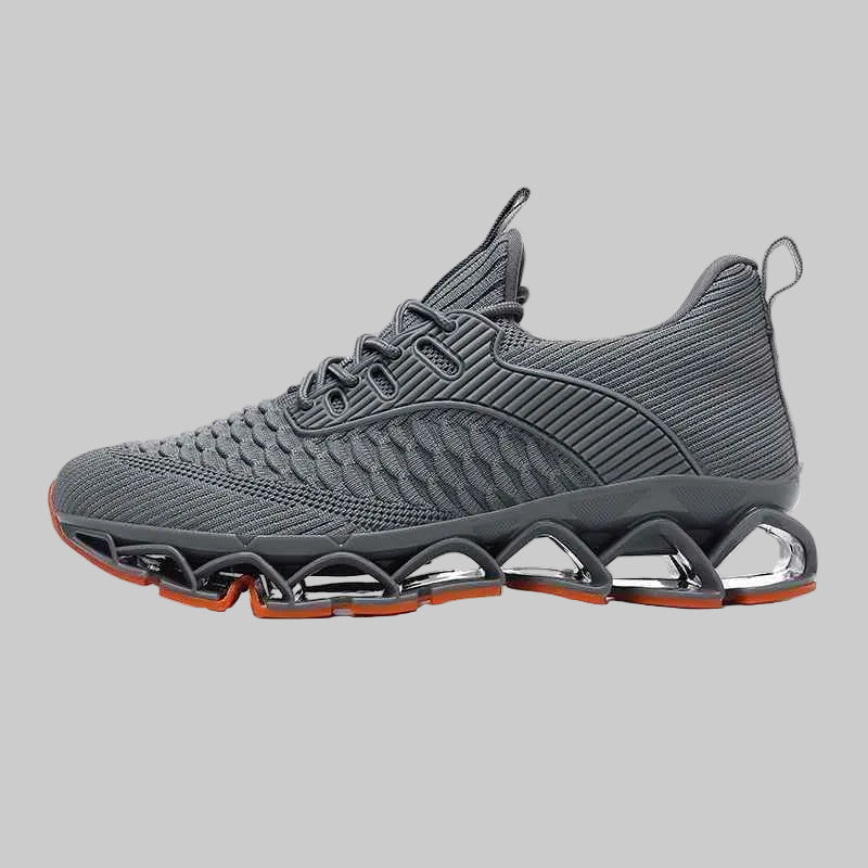 Gray athletic shoe with orange accents on a white background
