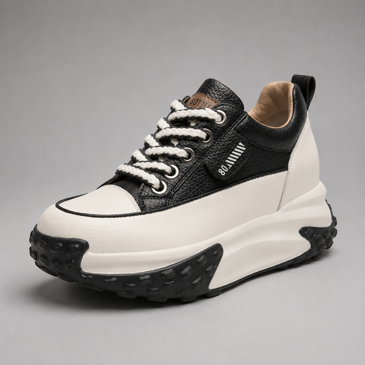 Black and white sneaker with brand logo on a gray background