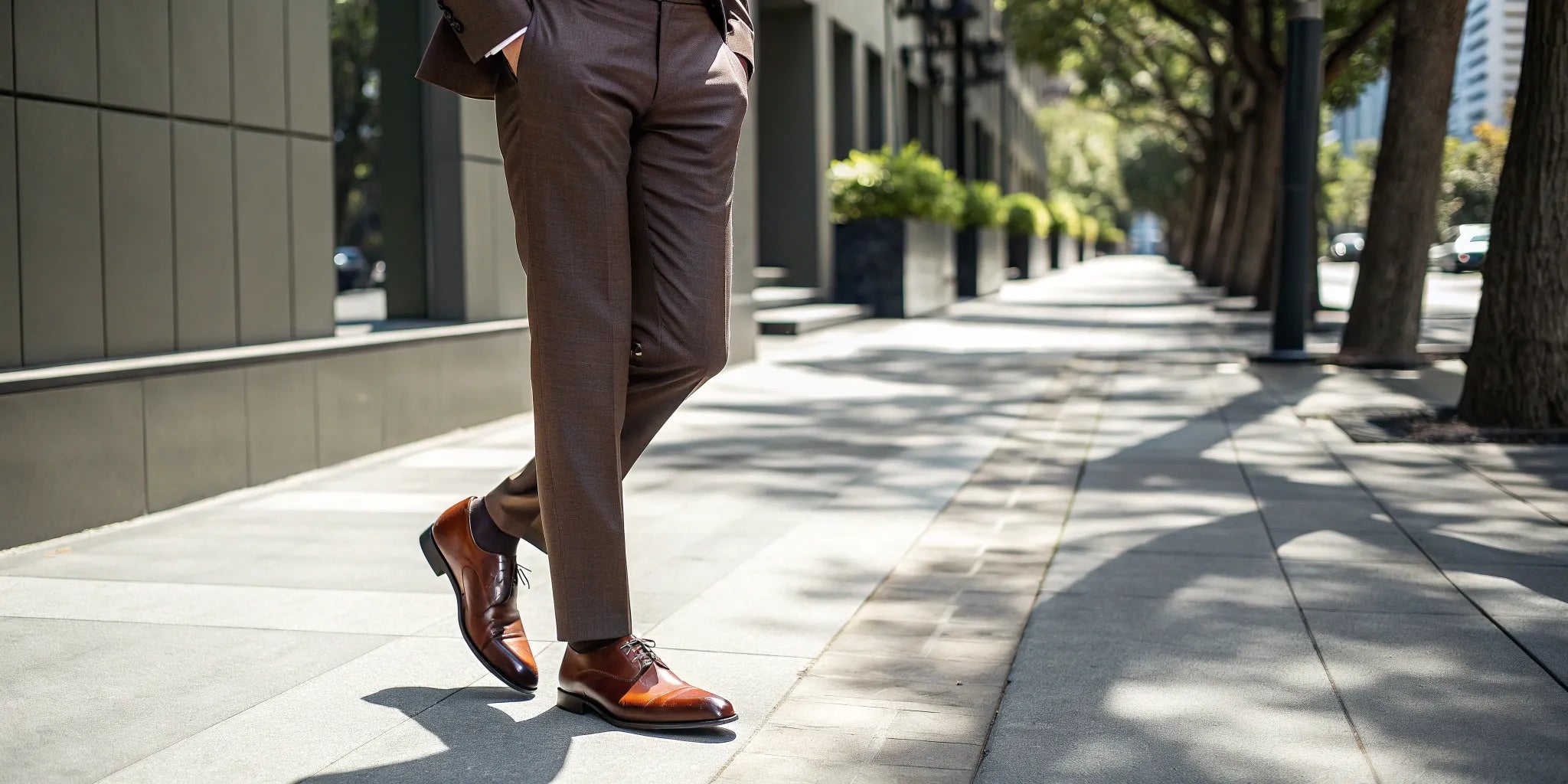 A man wearing brown dress shoes that add height with his suit.