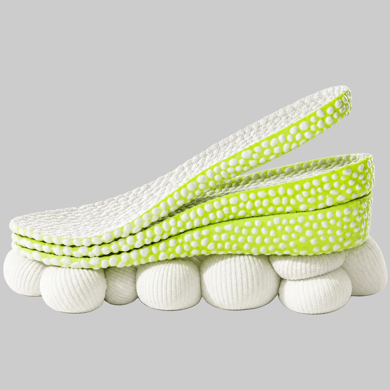A pair of contoured orthopedic shoe inserts with a bright lime green and white textured upper and a white ribbed cushioned lower base, shown on a plain white background.